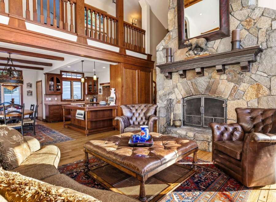 Step into luxury with this stunning property featuring a grand stone fireplace, perfect for cozy evenings.