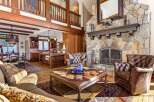 Step into luxury with this stunning property featuring a grand stone fireplace, perfect for cozy evenings.