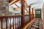 This stunning property boasts a beautifully designed interior with exquisite wooden accents and a captivating stone fireplace.