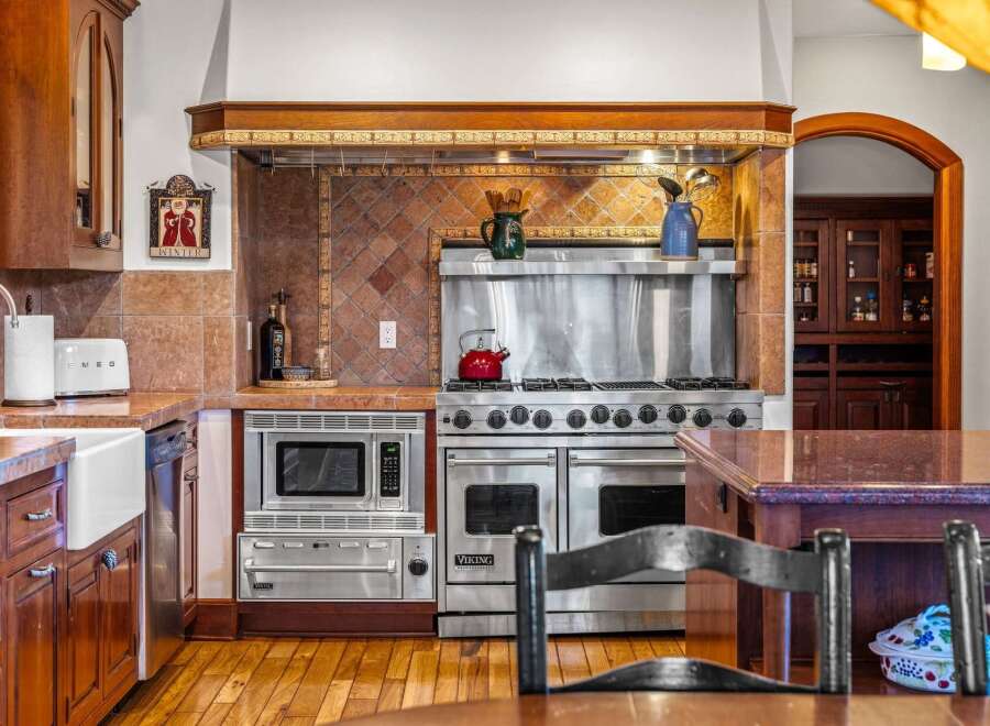 This stunning kitchen boasts high-end appliances and custom cabinetry, perfect for the discerning chef.