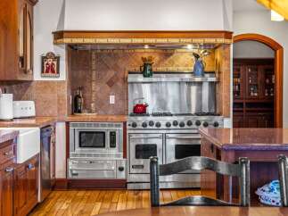 This stunning kitchen boasts high-end appliances and custom cabinetry, perfect for the discerning chef.