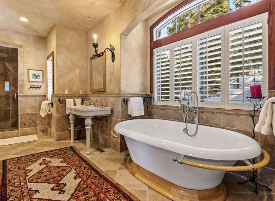 Indulge in luxury within this exquisite bathroom, featuring a stunning clawfoot tub and elegant fixtures.