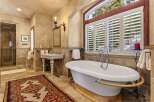 Indulge in luxury within this exquisite bathroom, featuring a stunning clawfoot tub and elegant fixtures.