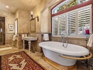 Indulge in luxury within this exquisite bathroom, featuring a stunning clawfoot tub and elegant fixtures.