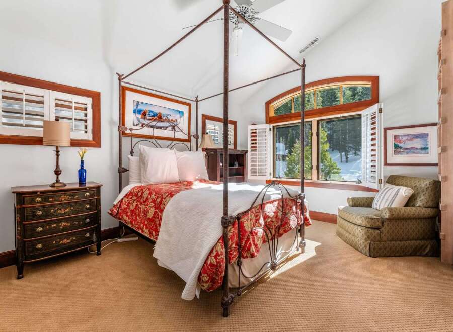 Step into luxury with this stunning bedroom featuring a four-poster bed and elegant decor.