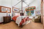 Step into luxury with this stunning bedroom featuring a four-poster bed and elegant decor.