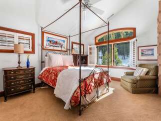 Step into luxury with this stunning bedroom featuring a four-poster bed and elegant decor.