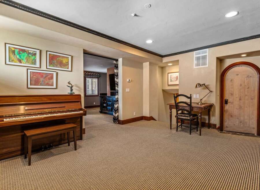 This elegant property boasts a spacious living area with a grand piano, perfect for musical enthusiasts.