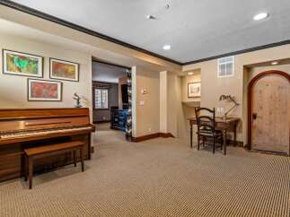 This elegant property boasts a spacious living area with a grand piano, perfect for musical enthusiasts.
