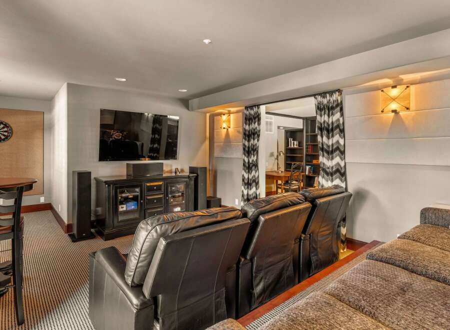 Step into luxury with this stunning home theater! Featuring a large screen, comfortable seating, and a stylish design, this space is perfect for movie nights and entertaining guests.