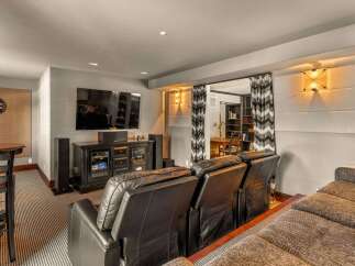 Step into luxury with this stunning home theater! Featuring a large screen, comfortable seating, and a stylish design, this space is perfect for movie nights and entertaining guests.