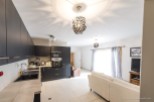 Modern kitchen with sleek black cabinets and integrated appliances.