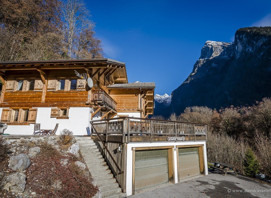 This stunning chalet boasts a spacious wooden exterior, complete with a large balcony and double garage.