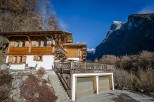 This stunning chalet boasts a spacious wooden exterior, complete with a large balcony and double garage.