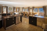 This stunning chalet boasts a spacious open-plan kitchen and dining area, perfect for entertaining guests.