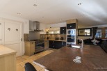 This stunning kitchen boasts modern appliances and ample counter space, perfect for culinary enthusiasts.