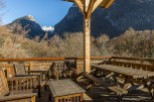 Mountain view deck with wooden picnic table and chairs.