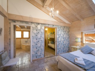 Charming bedroom with ensuite bathroom and bunk beds, perfect for families.