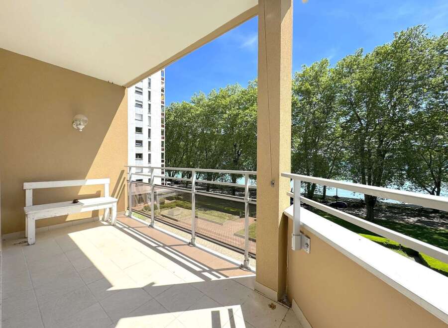 Enjoy breathtaking views from this stunning balcony overlooking the serene lake and lush greenery.