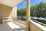 Enjoy breathtaking views from this stunning balcony overlooking the serene lake and lush greenery.