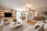 Experience modern living in this beautifully appointed living and dining area, featuring a sleek entertainment unit with integrated lighting and ample shelving.