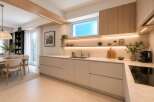 Experience modern living in this stunning kitchen featuring sleek, handleless cabinetry and integrated LED lighting for a sophisticated ambiance.