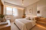 Experience serene living in this beautifully appointed bedroom, featuring a plush king-size bed adorned with soft, neutral linens and accent pillows.