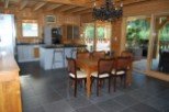 This stunning log cabin boasts a spacious open-plan kitchen and dining area, perfect for entertaining.