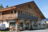 This charming chalet-style building boasts a spacious balcony, large windows, and ample parking.