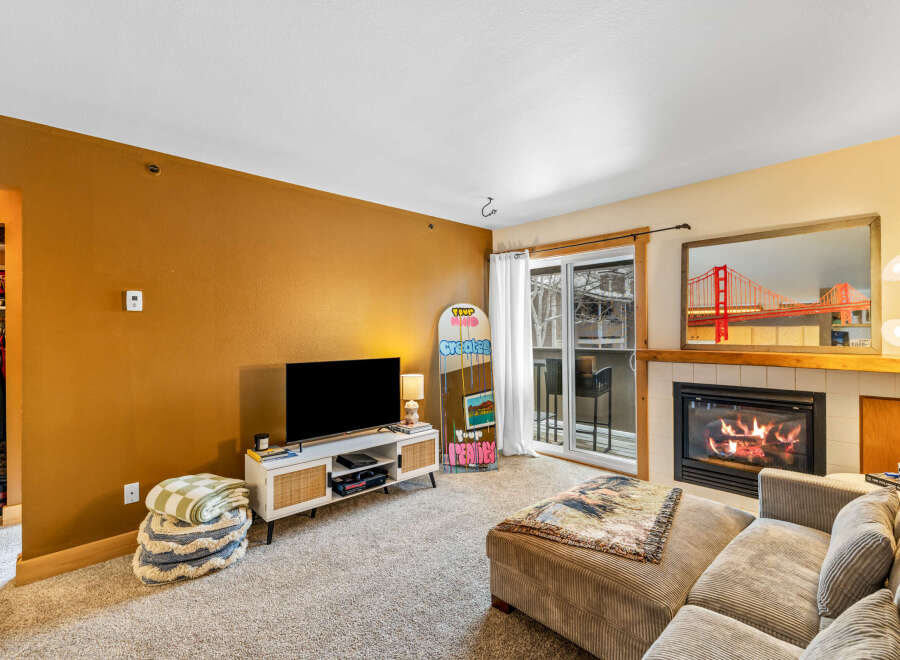 This cozy living space features a modern fireplace, perfect for those chilly evenings.