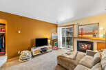 This cozy living space features a modern fireplace, perfect for those chilly evenings.