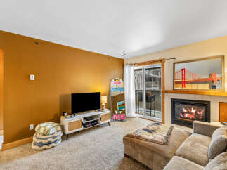 This cozy living space features a modern fireplace, perfect for those chilly evenings.