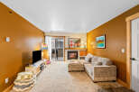 Step into this inviting living space, featuring a cozy fireplace and a comfortable sectional sofa, perfect for relaxing evenings.