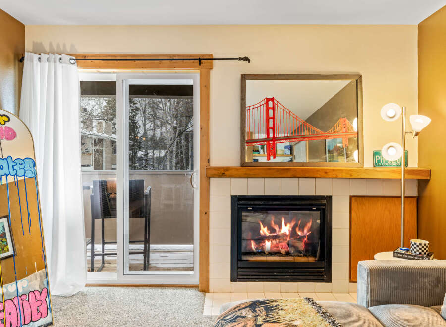 Cozy up by the fireplace in this inviting living space! This property boasts a stunning view, a modern fireplace, and stylish decor.