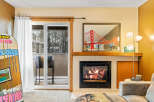 Cozy up by the fireplace in this inviting living space! This property boasts a stunning view, a modern fireplace, and stylish decor.
