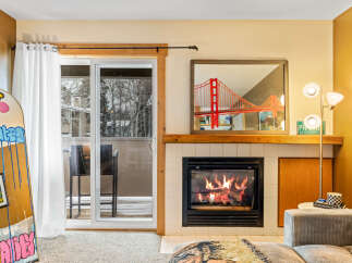 Cozy up by the fireplace in this inviting living space! This property boasts a stunning view, a modern fireplace, and stylish decor.