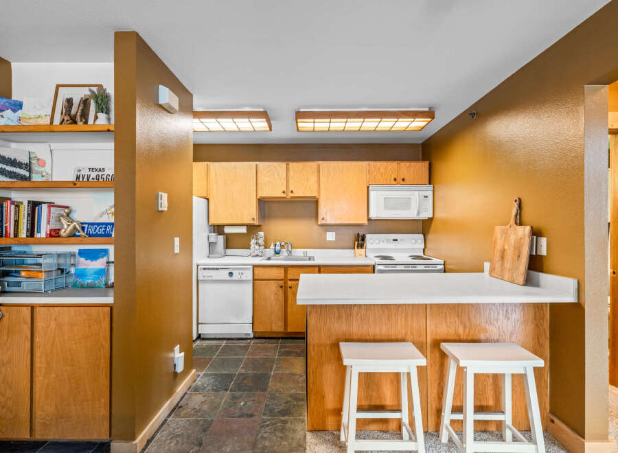 This charming kitchen features a warm, inviting atmosphere with its wooden cabinetry and countertops.