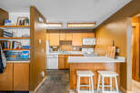 This charming kitchen features a warm, inviting atmosphere with its wooden cabinetry and countertops.