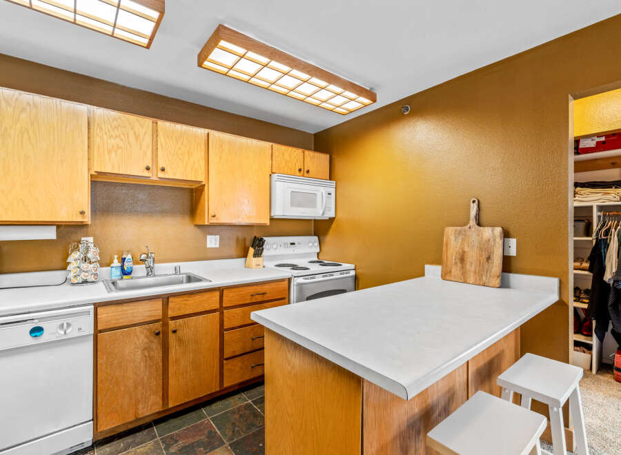 This charming kitchen features warm wooden cabinetry, offering ample storage and a classic aesthetic.