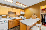 This charming kitchen features warm wooden cabinetry, offering ample storage and a classic aesthetic.