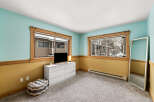 This inviting bedroom boasts a serene atmosphere with its calming color palette and ample natural light.