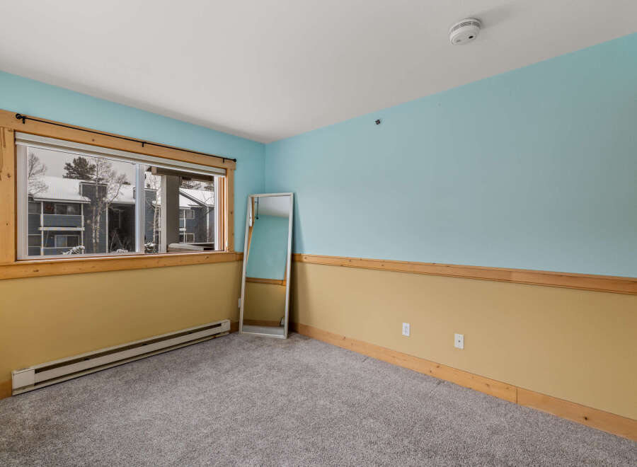 This inviting room features a large window that offers stunning views and natural light.
