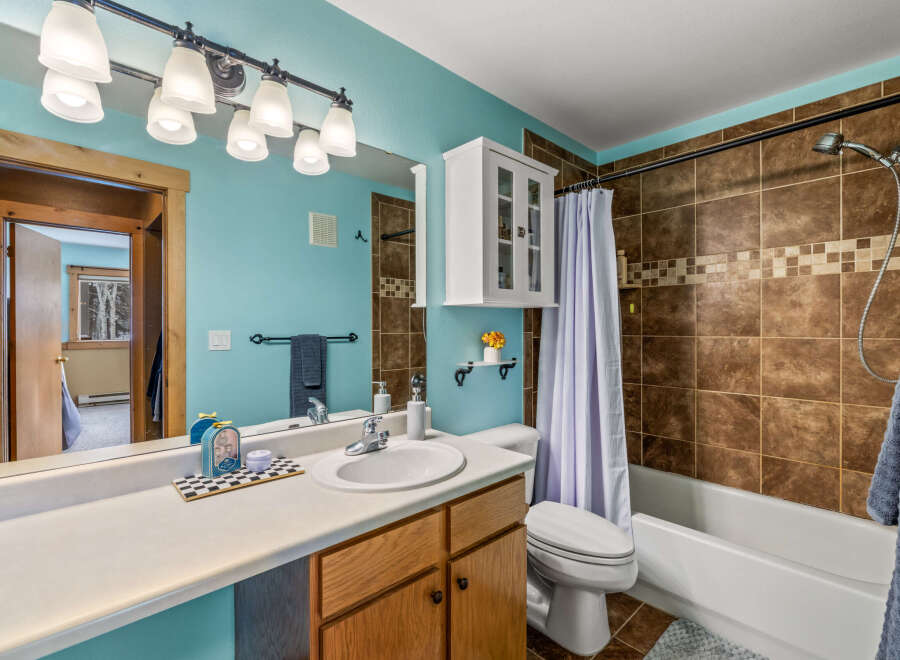 This charming bathroom features a bright and airy design, perfect for starting your day.