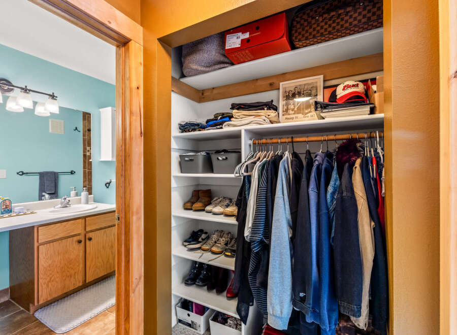 Step into this charming home and discover a well-organized closet, perfect for keeping your wardrobe tidy.
