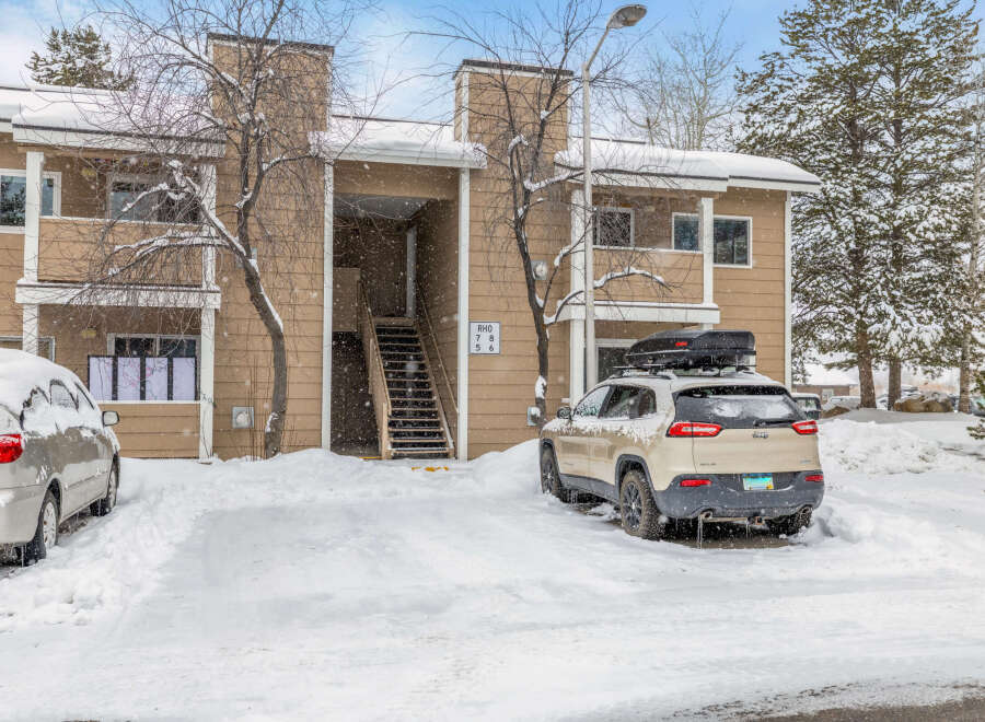 This charming property offers a cozy retreat with its snow-covered exterior and inviting atmosphere.