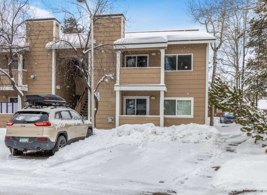 This charming property offers a cozy retreat with its snow-covered exterior and inviting atmosphere.