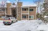 This charming property offers a cozy retreat with its snow-covered exterior and inviting atmosphere.