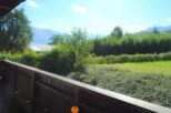 Mountain view from a wooden balcony.