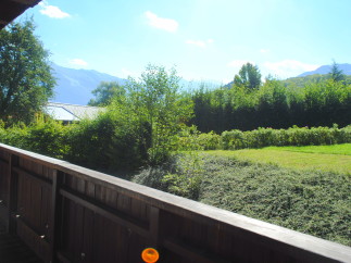 Mountain view from a wooden balcony.
