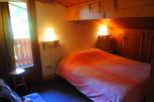 Cozy chalet bedroom with wooden accents and a comfortable bed.
